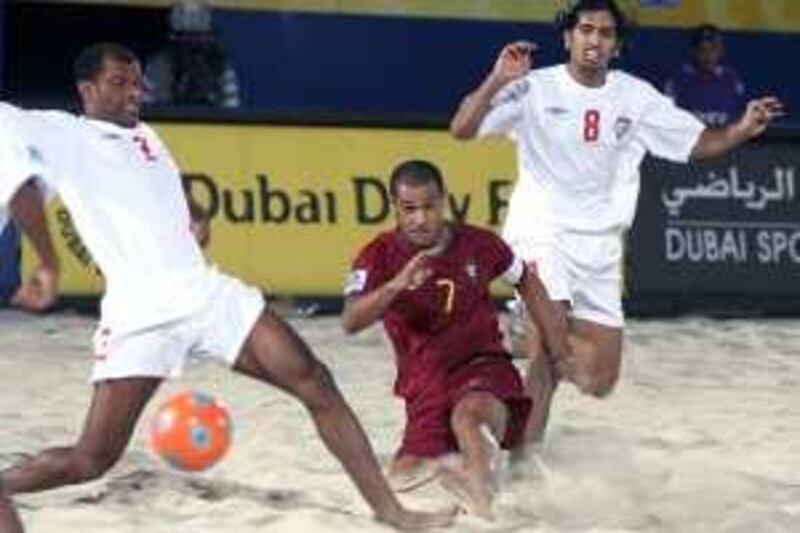 DUBAI, UNITED ARAB EMIRATES - November 16:  Action between Qambar Sadeqi of UAE (in white, L) and Madjer of Portugal (in red) on the first day of the FIFA Beach Soccer World Cup Dubai 2009, held at the Umm Suqueim beach in Dubai on November 16, 2009.  (Randi Sokoloff / The National)  For News/Sport
