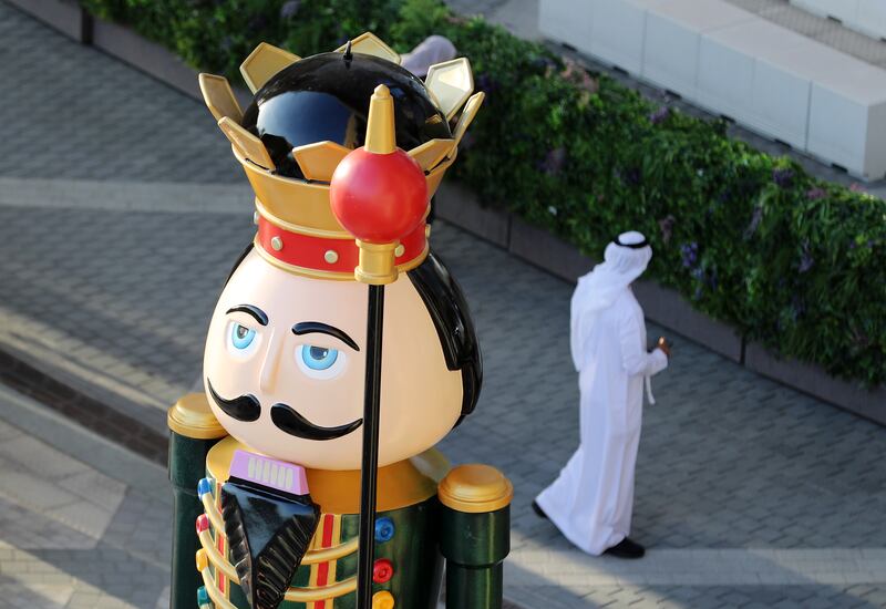 An Emirati gentleman walks pasted a giant christmas decoration at Expo 2020 in Dubai. Chris Whiteoak/ The National