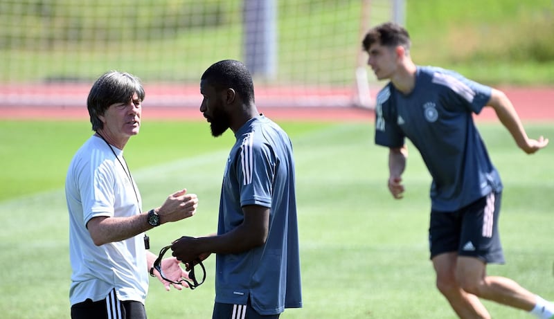 Germany coach Joachim Low speaks to defender Antonio Ruediger ahead of the clash with Portugal. AFP