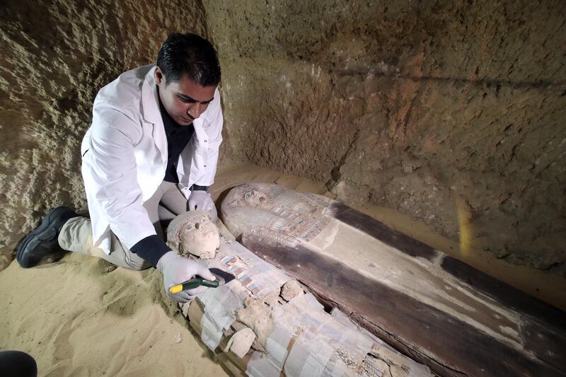 An Egyptian archaeologist works on a sarcophagus at the site of an ancient old Kingdom cemetery that was uncovered at the south-eastern side of Giza Plateau, Giza, Egypt.  EPA