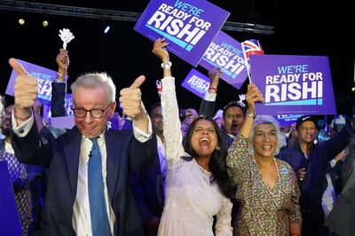 Michael Gove, Rishi Sunak's wife Akshata Murthy and mother Usha Sunak at Wembley Arena. PA