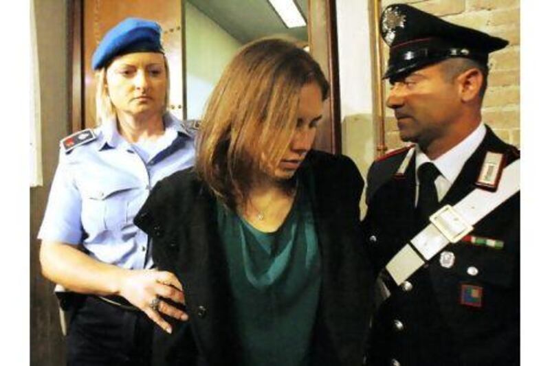Amanda Knox, centre, is escorted as she arrives for an appeal hearing at the court in Perugia, Italy yesterday. Antonio Calanni / AP Photo