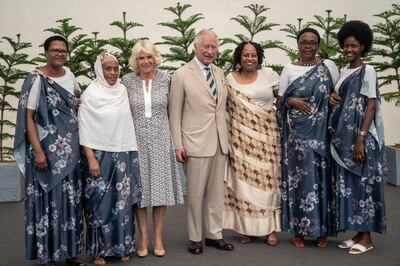 Prince Charles, centre, and Camilla, third left, pose for a photo with a group of survivors during a visit to the Kigali Genocide Memorial. AFP