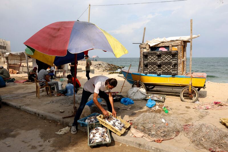 Fishermen sell crabs along the beach in Gaza. AFP