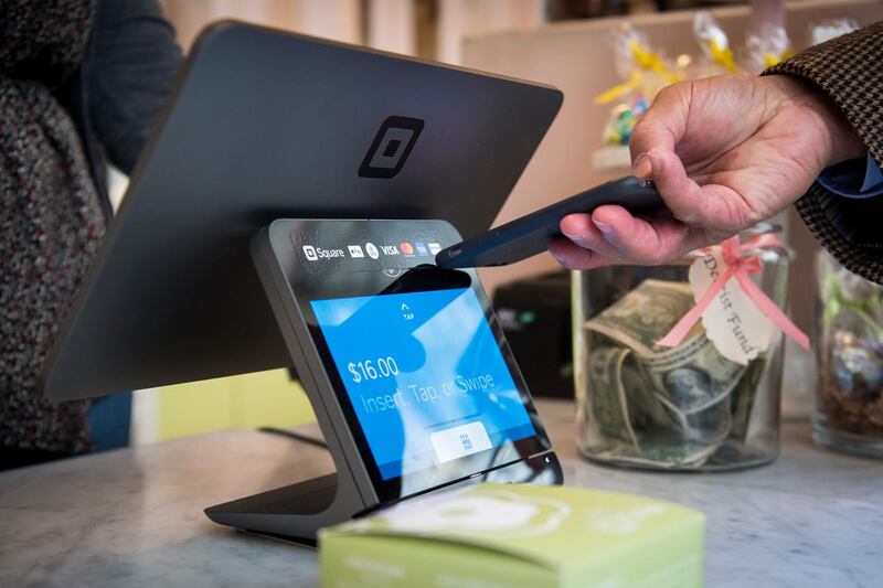 A customer uses an Apple Inc. iPhone to make a payment on a Square Inc. device in San Francisco, California, U.S., on Tuesday, March 27, 2018. The mobile payment market is anticipated to grow reaching a market value of $4,574 billion by 2023, according to data provided by Allied Market Research (AMR). The growth projections are attributed to an increasing demand for hassle-free purchase of goods and services, as well as an increased preference of consumers toward digital and cashless payments. Photographer: David Paul Morris/Bloomberg