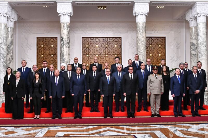 Egyptian President Abdel Fattah El Sisi, centre, poses with Egypt's new Cabinet, led by Prime Minister Mostafa Madbouly, fourth left, at Al Ittihadiya Palace in Cairo on Wednesday. AP