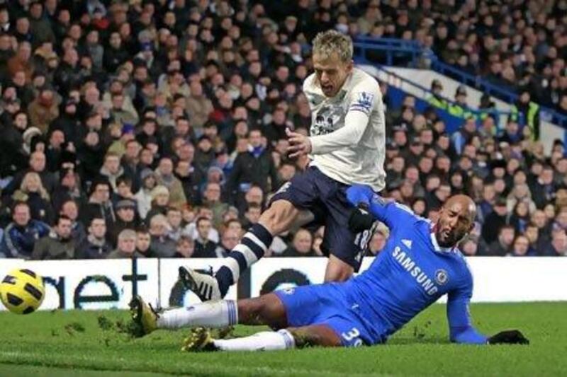Chelsea's striker Nicolas Anelka slides while under attack by Everton's Phil Neville. 
Ian Kington / AFP