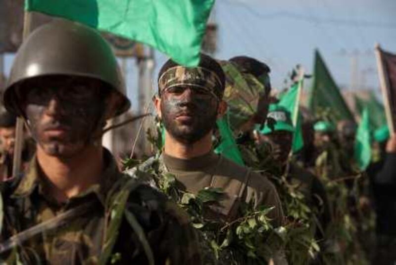 Masked Palestinian members of the militant group Hamas are seen during a demonstration in the Nusseirat refugee camp, central Gaza Strip, Friday, Dec. 11, 2009. The Hamas rulers of the Gaza Strip on Friday began celebrations marking the Islamist movement's 22nd anniversary with parades and the unveiling of a huge mural depicting rockets targeting Israel.(Photo by Heidi Levine/Sipa Press). *** Local Caption ***  IMG_6480.JPG