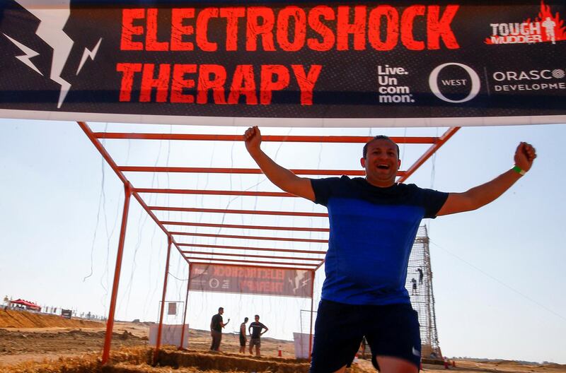 A competitor expresses his delight as he crosses the finish line, during Egypt's Tough Mudder challenge. Reuters