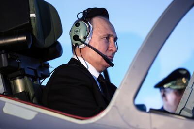 President Vladimir Putin sits in a cockpit of a flight simulator in Krasnodar, Russia. AP