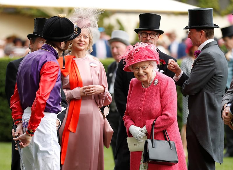 Britain's Queen Elizabeth speaks with a jockey at Ascot. Reuters