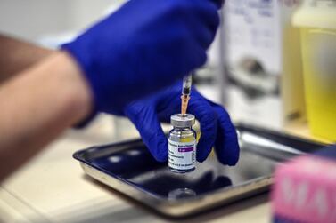 A nurse prepares a dose of the AstraZeneca COVID-19 vaccine. AP