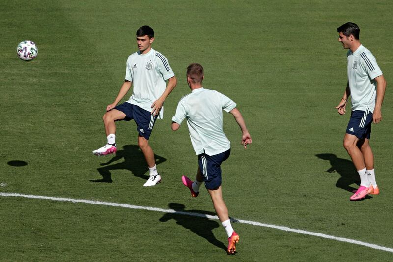 Spain's forward Pedri (L) passes the ball during a training session at La Cartuja Stadium in Sevilla. AFP