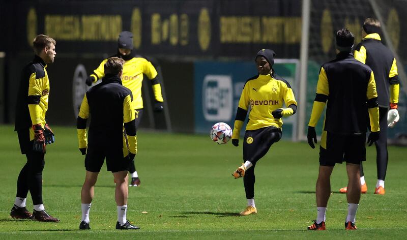 Dortmund's Youssoufa Moukoko passes the ball during training. EPA