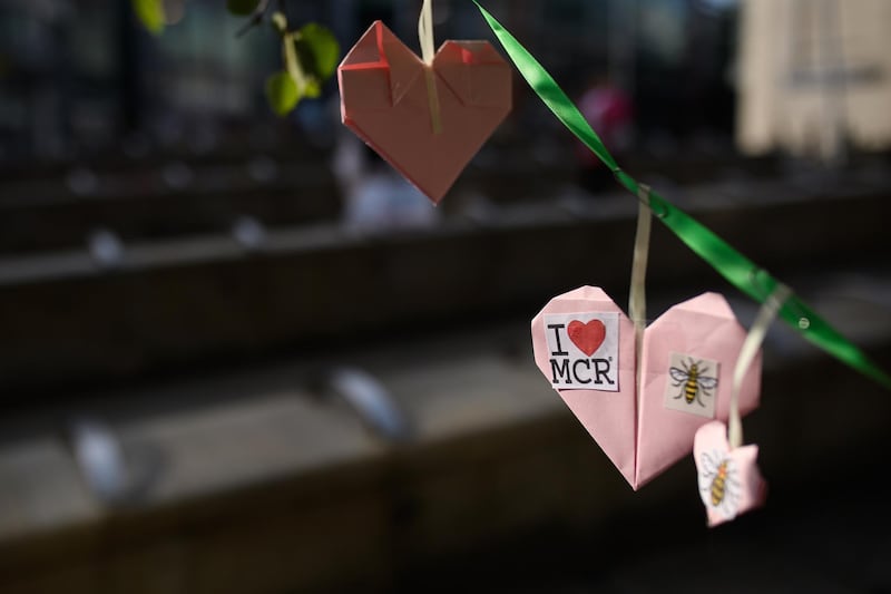 Three of the 27,000+ handmade hearts that have been donated to Beth Clarke's #aheart4mcr Twitter campaign are seen on the morning of the first anniversary of the terrorist attack in central Manchester. Getty