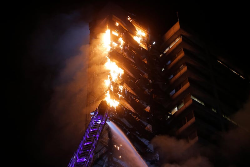 Flames engulf the iconic Enel building in downtown Santiago. AFP