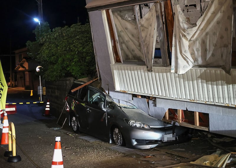 A car crushed by a collapsed house in the city of Suzu, Ishikawa prefecture. AFP