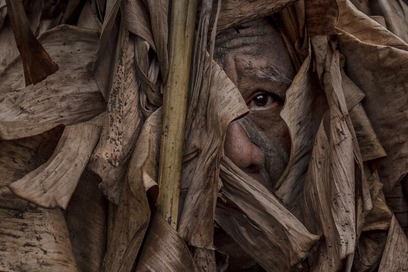 Devotees covered in mud and dried banana leaves take part in the Taong Putik ("mud people") Festival  in the village of Bibiclat in Aliaga town, Nueva Ecija province, Philippines. Each year, the residents of Bibiclat village in Aliaga town celebrate the Feast of Saint John by covering themselves in mud, dried banana leaves, vines, and twigs as part of a little-known Catholic festival. Getty Images