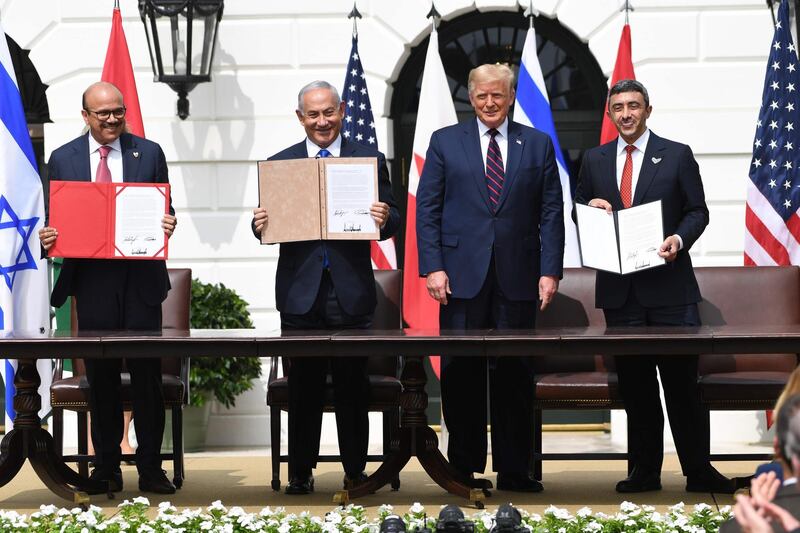 Sheikh Abdullah and, from left, Mr Al Zayani, Mr Netanyahu and Mr Trump after the signing ceremony. AFP