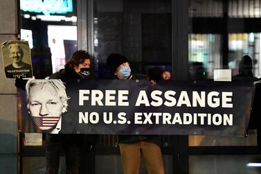 Protesters hold a sign supporting WikiLeaks founder Julian Assange. AFP