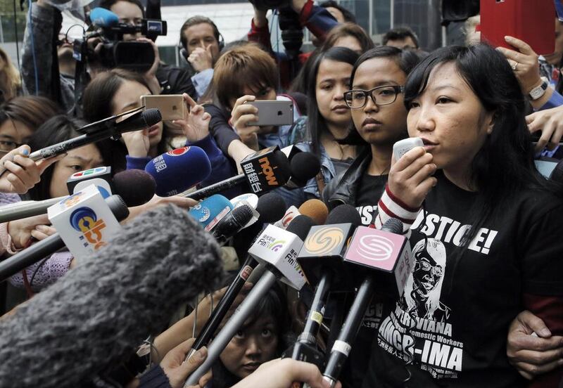 Indonesian maid Erwiana Sulistyaningsih, right, speaks to reporters outside a court in Hong Kong on February 27, 2015. Vincent Yu / AP