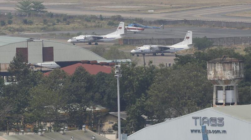 A military aircraft, left, taxis on the runway in hazy weather at the Tan Son Nhat airport in Ho Chi Minh City. Reuters