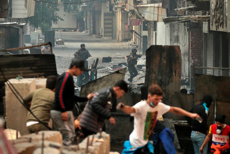 Security forces try to disperse anti-government protesters during clashes in Baghdad, Iraq. AP Photo