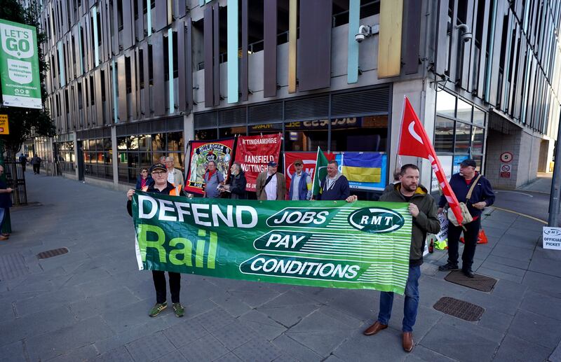 RMT members protest over pay, jobs and conditions outside Nottingham station in central England. PA