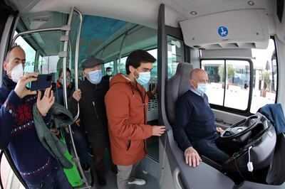 Avanza bus company driver Cristobal Maldonado, 60, oversees an electric autonomous bus in autopilot mode during a month test phase with passengers in Malaga, Spain February 24, 2021. REUTERS/Jon Nazca
