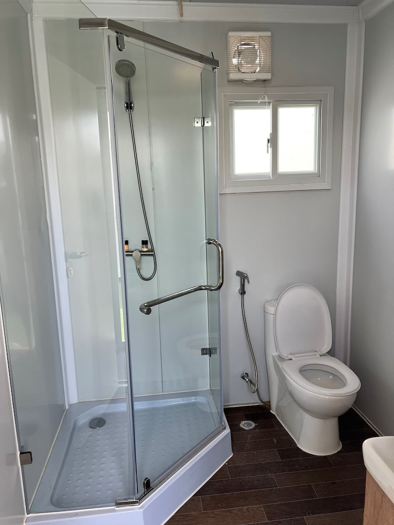 The toilet and shower inside a cabin