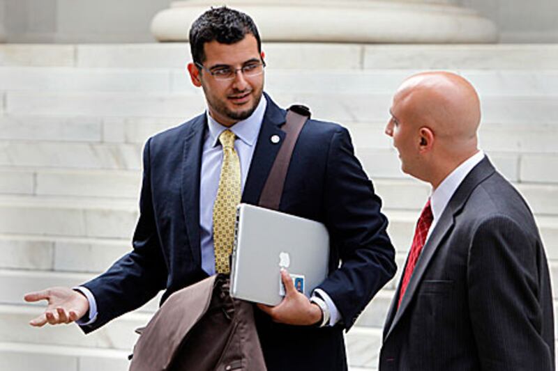 Muneer Awad, left, executive director of the Council on American-Islamic Relations in Oklahoma talks with his lawyer Gadeir Abbas after leaving court in Denver.