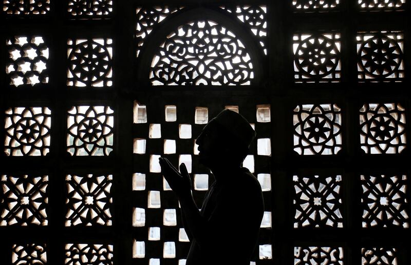 A Muslim man prays inside a shrine in Ahmedabad, India. Reuters