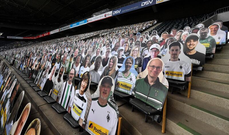 Thousands of cardboards with photos of Borussia Monchengladbach football fans are displayed on the stands at Borussia-Park on Tuesday, August 4. AP