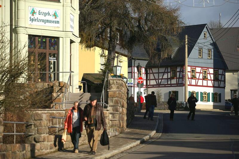 Visitors walk past the Ore Mountains Toy Museum on Hauptstrasse street in Seiffen, Germany. Sean Gallup / Getty Images