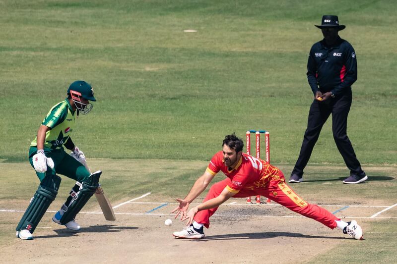 Zimbabwe's Ryan Burl fields off his own bowling. AFP