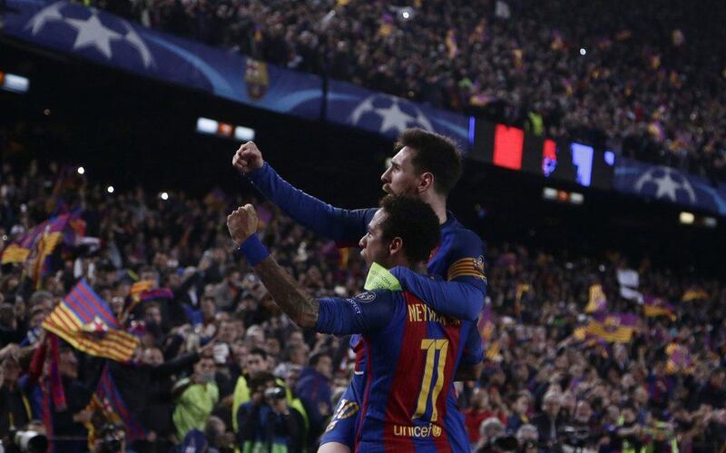 Barcelona's Lionel Messi celebrates with Neymar after their victory during the Champion League round of 16 against Paris Saint Germain at the Camp Nou stadium in Barcelona, Spain, on March 8, 2017. Emilio Morenatti / AP