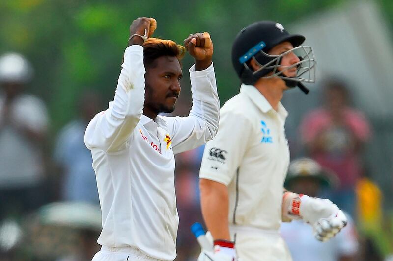 Sri Lanka's Akila Dananjaya (L) celebrates after dismissing New Zealand's John Watling (R) during the first day of the first Test cricket match between Sri Lanka and New Zealand at the Galle International Cricket Stadium in Galle on August 14, 2019. / AFP / Ishara S. KODIKARA
