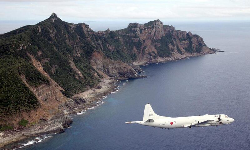 A Japanese Maritime Self-Defense Force plane flies over the disputed islets known as the Senkaku islands in Japan and Diaoyu islands in China. AFP

