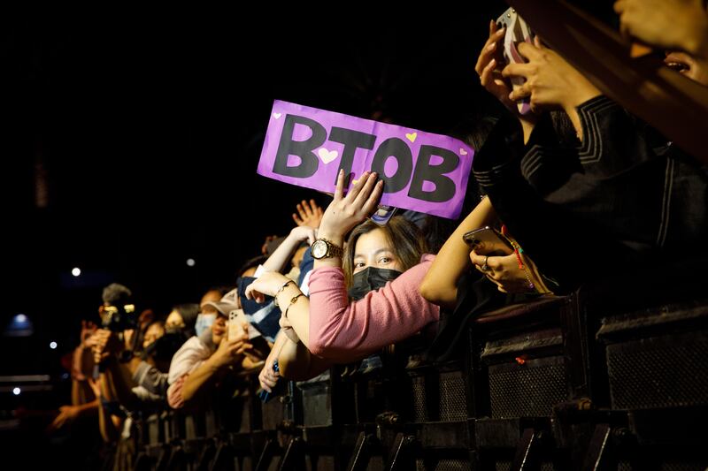 A fan holds up a sign with the name of K-pop group BTOB who performed virtually from South Korea.