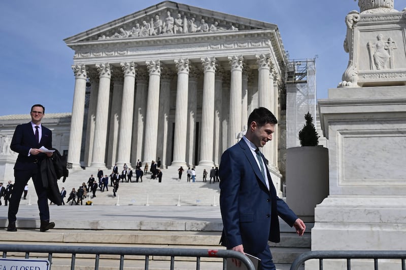 People walk out of the US Supreme Court in Washington after the end of oral arguments in a pair of lawsuits challenging laws passed in Texas and Florida that barred social media sites from curating political posts. AFP