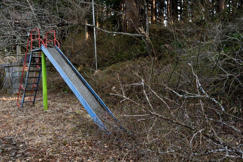 Abandoned equipment in an overgrown playground. NurPhoto via Getty Images
