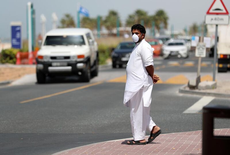 Dubai, United Arab Emirates - Reporter: N/A: A gentleman wears a mask while crossing a road in Jumeriah. Thursday, March 19th, 2020. Jumeriah, Dubai. Chris Whiteoak / The National