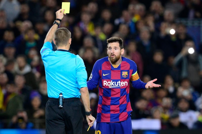 Barcelona's Lionel Messi is shown a yellow card for diving by French referee Clement Turpin. AFP