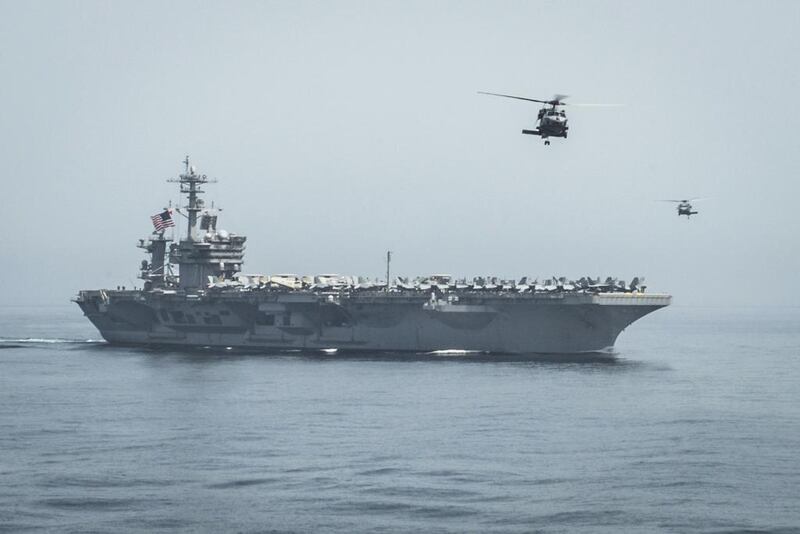 Helicopters fly from the aircraft carrier USS Theodore Roosevelt during a vertical replenishment with the aircraft carrier USS Carl Vinson in the Gulf of Oman. US Navy Media Content Services / AP Photo