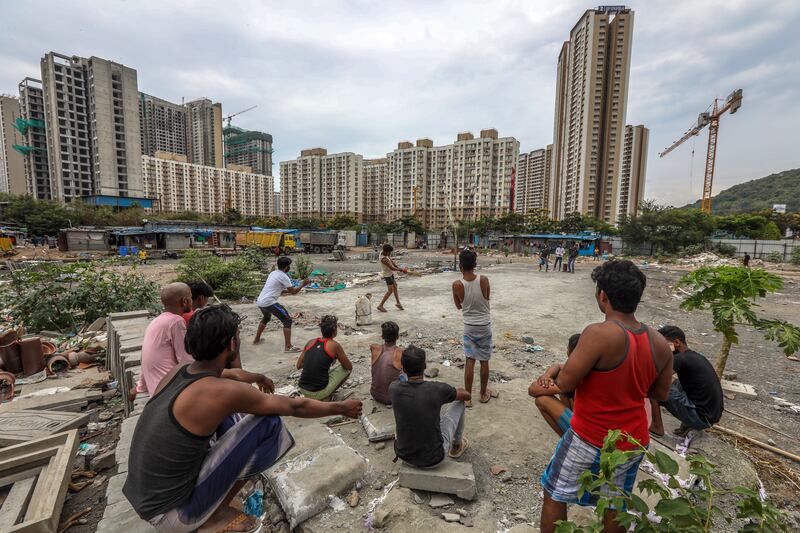 Indian labourers play cricket at a construction site in Mira Road, on the outskirts of Mumbai, on Labour Day. EPA 