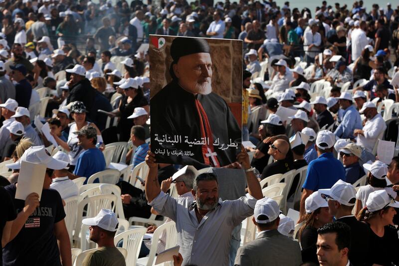 A mourner holds up a picture of former Maronite Patriarch Nasrallah Boutros Sfeir during his funeral Mass at the seat of the Maronite Church in Bkerke, Lebanon. AP Photo