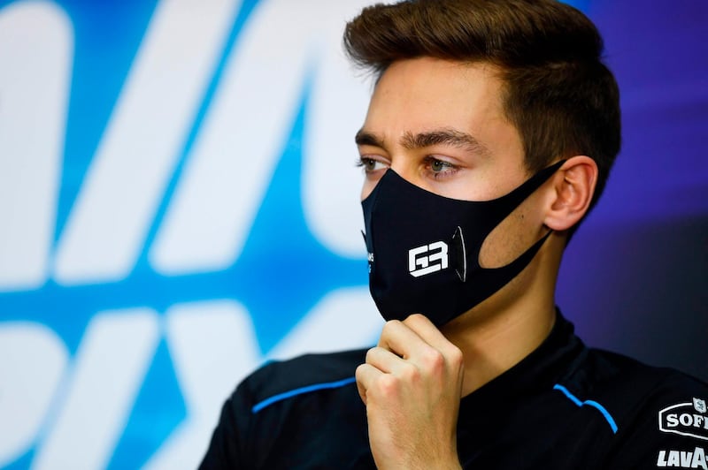 Williams' British driver George Russell adjusts his mask during the presser ahead of the Bahrain Formula One Grand Prix at the Bahrain International Circuit in the city of Sakhir on November 26, 2020. RESTRICTED TO EDITORIAL USE - MANDATORY CREDIT "AFP PHOTO / FIA / RUDY CAREZZEVOLI - NO MARKETING NO ADVERTISING CAMPAIGNS - DISTRIBUTED AS A SERVICE TO CLIENTS

 / AFP / FIA / Rudy Carezzevoli / RESTRICTED TO EDITORIAL USE - MANDATORY CREDIT "AFP PHOTO / FIA / RUDY CAREZZEVOLI - NO MARKETING NO ADVERTISING CAMPAIGNS - DISTRIBUTED AS A SERVICE TO CLIENTS

