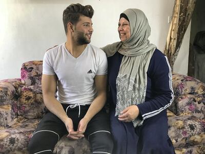 Samar Mamdoh with her oldest son Khaled, who continued his education after fleeing the civil war in Syria, before bullies forced him to drop out. Anna Zacharias / The National