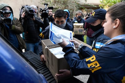 Police confiscate documents during a raid at the Buenos Aires hotel where the crew were staying.  AP Photo 