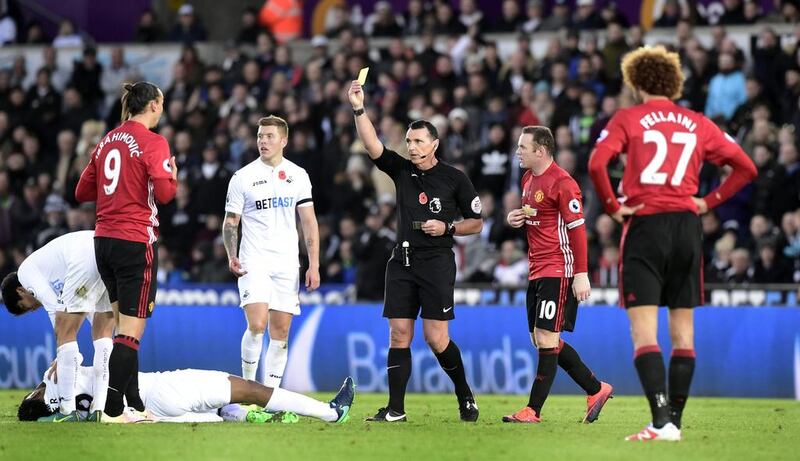 Manchester United’s Zlatan Ibrahimovic is shown a yellow card by referee Neil Swarbrick. Rebecca Naden / Reuters